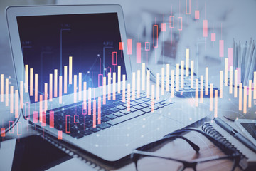 Forex graph hologram on table with computer background. Multi exposure. Concept of financial markets.