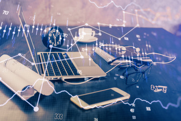 Obraz premium Financial graph colorful drawing and table with computer on background. Multi exposure. Concept of international markets.