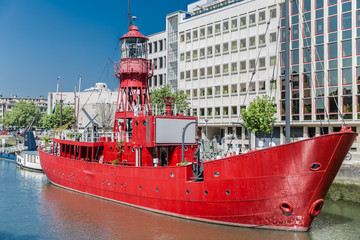Red boat anchored in a canal in the Dutch city of Rotterdam on a sunny day in the Netherlands...
