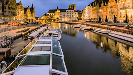 Leie river in the historic center of the city of Ghent, with the Graslei and Korenlei quays with anchored boats, quiet night with empty streets in the city of Belgium