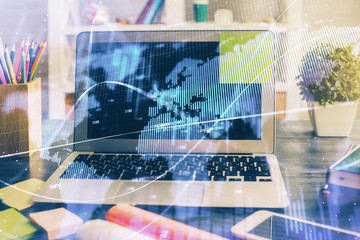 Financial graph colorful drawing and table with computer on background. Double exposure. Concept of international markets.