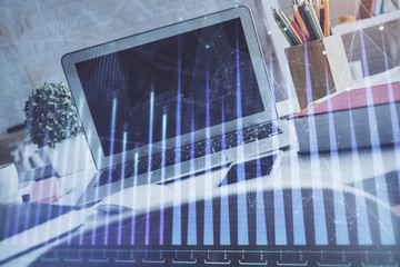 Stock market graph and table with computer background. Multi exposure. Concept of financial analysis.