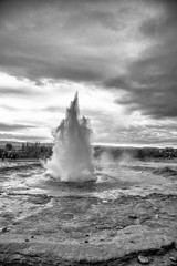 Geysir erupting in Iceland. Famous geyser on a cloudy day