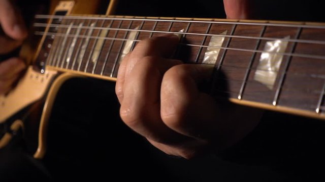 guitarist plays electric guitar at studio . slow motion 50p closeup	