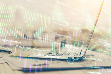 Stock market chart hologram drawn on personal computer background. Multi exposure. Concept of investment.