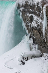 Naklejka na ściany i meble Winter wonderland - little house under Niagara Falls