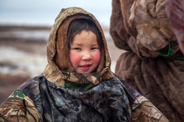 The extreme north, Yamal, the pasture of Nenets people, girl on vacation playing near reindeer pasture