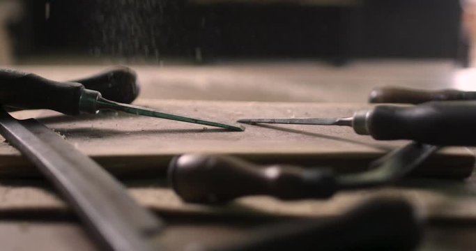 Woodworker's Tools On A Wooden Table With Saw Dust Sprinkling On It In A Wood Working Studio In London, Ontario, Canada - Extreme Close Up 4k 60p