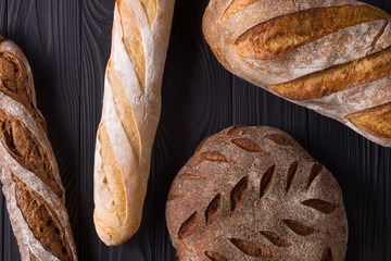 Top view photo of fresh baked bread on painted black wooden table