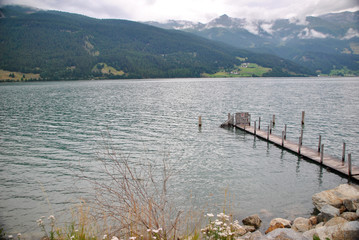 alke in the mountains with a wooden pier