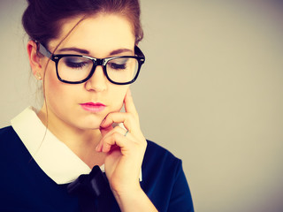 Focused business woman looking down thinking