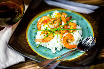 Southern shrimp and grits on a rustic plate. 