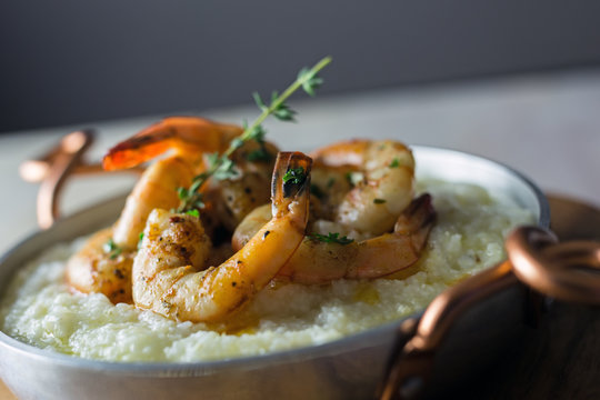 Shrimp and grits in a copper handled dish.  Copy space. 