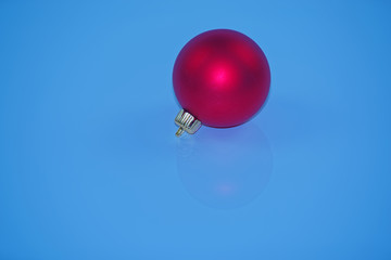 Red christmas ball on blue background