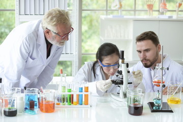 Scientists are working in science labs.Close-up of a scientistYoung female scientist looking through a microscope in a laboratory doing research