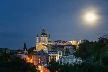 Fototapeta na wymiar Evening Kiev, panorama of the evening city, the moon shines over the city, Kiev, Ukraine