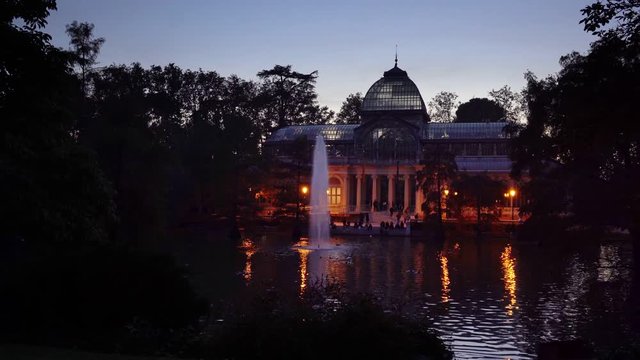 Sunset view of Crystal Palace or Palacio de cristal in Retiro Park in Madrid, Spain. The Buen Retiro Park is one of the largest parks of the city of Madrid, Spain