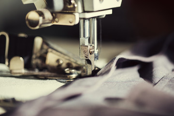 Closeup the sewing machine and item of clothing.