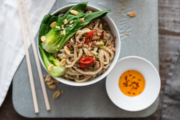 Chinese Udon Noodles with Minced Pork in Spicy Sauce Served with Pak Choi