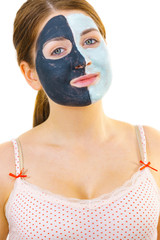 Girl with black white mud mask on face