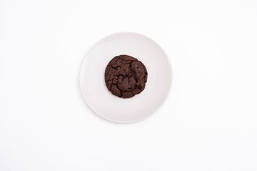 Chocolate and cocoa cookies on plate. Overhead view of cooky on isolated background.