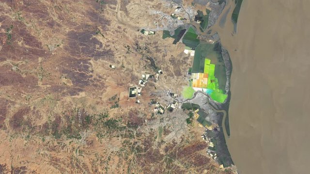 Salt evaporation ponds industrial site aerial satellite view near town of Bhavnagar India. Contains public domain image by Nasa