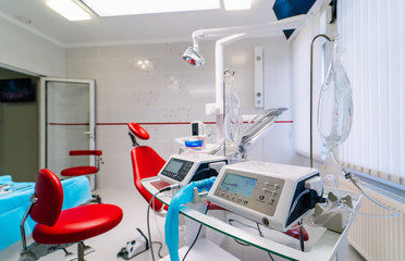 dentistry, medicine, medical equipment and stomatology concept - interior of new modern dental clinic office with chair