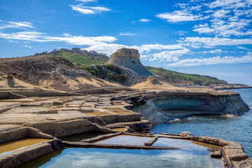 Xwejni bay with salt pans and exotic hill Qolla l-Bajda, Marsalforn, Gozo, Malta, Europe