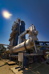 Outdoor asphalt mixes station. Loading equipment. Asphalt mixture. Selective focus.