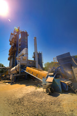 Outdoor asphalt mixes station. Loading equipment. Asphalt mixture. Selective focus.