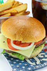 burger with beef, fritters and glass of cola on a white background