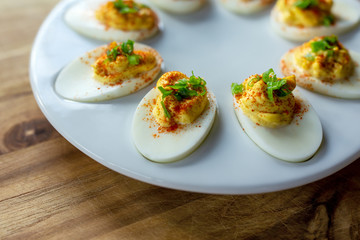 Deviled eggs on a small white tray, close up view. 