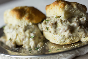 Southern style buttermilk biscuits and gravy on a silver tray. 