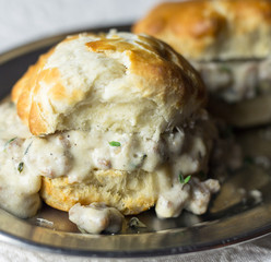 Southern style buttermilk biscuits and gravy on a silver tray. 