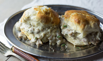 Southern style buttermilk biscuits and gravy on a silver tray. 