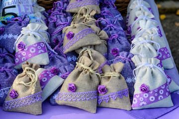 Group of textile bags with dried lavender flowers and leaves, available for sale at a traditional weekend market