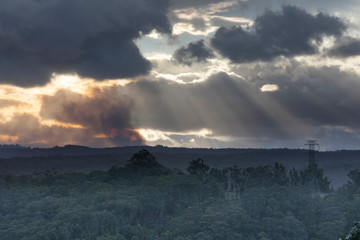 Fire fighting helicopters flying in smoke during a bush fire in The Blue Mountains in Australia