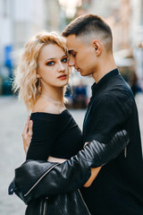 Portrait of attractive couple. Exquisite blonde looks into the camera