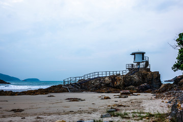 Fototapeta na wymiar The lifeguards observation tower on the rocks and sand of Big Wave Beach in Hong Kong at sunrise - 1