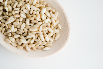 Wheat grain in wooden spoon