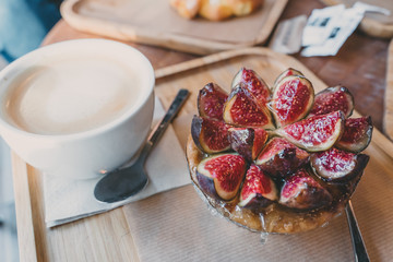 Delicious beautiful fig tartlet pastry. Fig fruit cut in half. Hight pastry, desert.