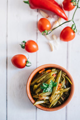 Turkish traditional Fresh Beans food casserole in bowl. Green beans olive oil whiteboard on the floor