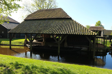 Dutch old wooden house with the parking place of a boat in the canal, Netherlands