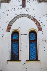 A window with a metal grille in an old house