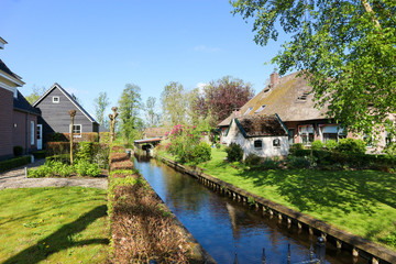 Fototapeta na wymiar Rural holland landscape - cosy house on canal in small town Giethoorn, Netherlands