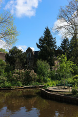 Beautiful spring view of small dutch village Giethoorn with canals and cosy houses