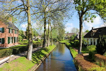 Fototapeta na wymiar Small canal in Netherlands in sunny spring day, Giethoorn