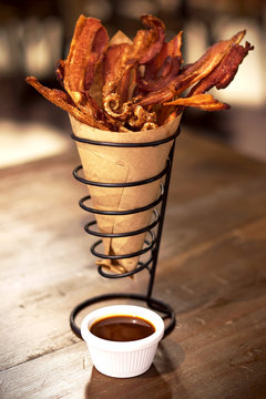 Hot fried bacon pieces and accompaniment