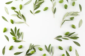 Poster Frame or borders made of fresh green olive fruit with leaves on white background. Top view. © vetre