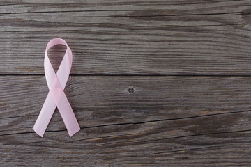pink ribbon breast cancer on wooden background. Top view